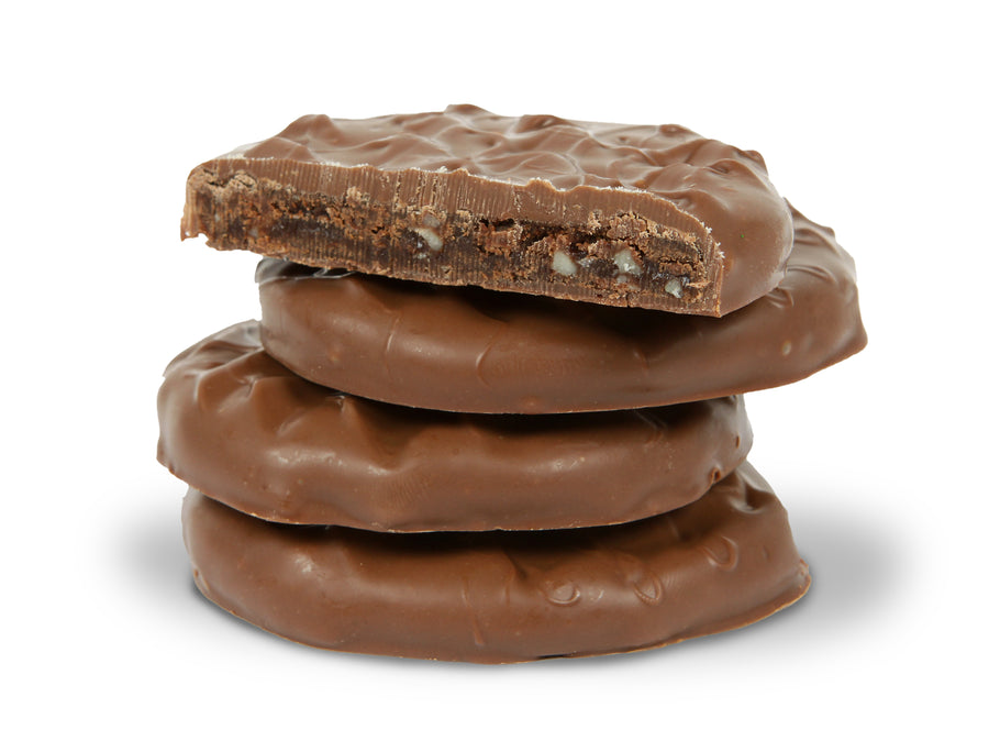 Mud Pies stacked - A mixture of chocolate, caramel, and peanuts wrapped in milk chocolate.